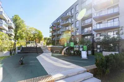 a playground in front of a apartment building at Brand New Central Panorama (SELF CHECK-IN) in Vilnius