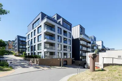 an apartment building on a street at Brand New Central Panorama (SELF CHECK-IN) in Vilnius