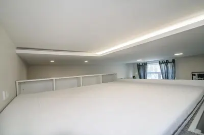 a large white bed in a room with a window at Modern 1BR / Near Gates of Dawn / Special Offer in Vilnius