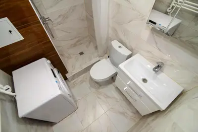 a white bathroom with a toilet and a sink at Modern 1BR / Near Gates of Dawn / Special Offer in Vilnius