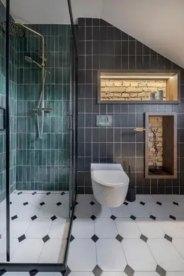 a bathroom with a toilet and a glass shower at Cozy Penthouse in Vilnius