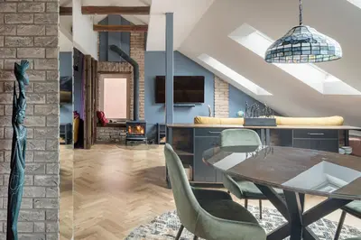 a dining room with a table and chairs at Cozy Penthouse in Vilnius
