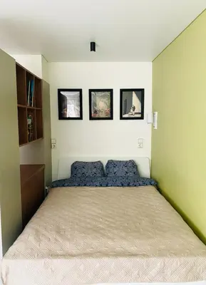 a bedroom with a bed with four pictures on the wall at Modern & Cozy Gem - Spacious Central Retreat with private entrance in Vilnius