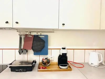 a kitchen counter with a coffee maker on a cutting board at Modern & Cozy Gem - Spacious Central Retreat with private entrance in Vilnius