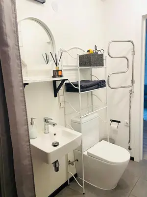 a white bathroom with a sink and a toilet at Modern & Cozy Gem - Spacious Central Retreat with private entrance in Vilnius