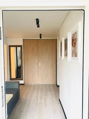 a living room with a sliding door and a couch at Modern & Cozy Gem - Spacious Central Retreat with private entrance in Vilnius