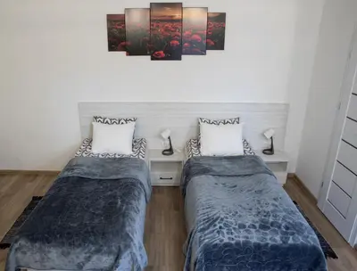 two beds in a small room with two at Svečių namai Aurėja in Kėdainiai