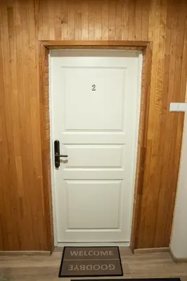 a white door with a welcome sign in front of it at Svečių namai Aurėja in Kėdainiai