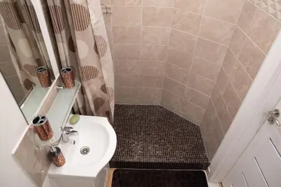 a small bathroom with a sink and a shower at Svečių namai Aurėja in Kėdainiai