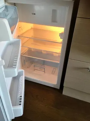 an open refrigerator with its door open and its contents at Natalex MicroLofts in Vilnius