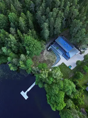 an aerial view of a house in the middle of a lake at Svedresort in Švedriškė
