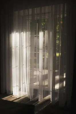 a window with white curtains in a room at Svedresort in Švedriškė