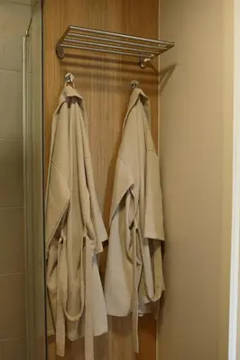 two towels are hanging on a rack in a bathroom at Svedresort in Švedriškė