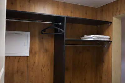 a towel rack in a bathroom with a wooden wall at Svedresort in Švedriškė