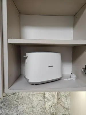 a toaster oven sitting on a shelf in a kitchen at Pleasant stay 1-bedroom apartment in Šiauliai