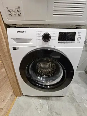 a washing machine is sitting in a kitchen at Pleasant stay 1-bedroom apartment in Šiauliai