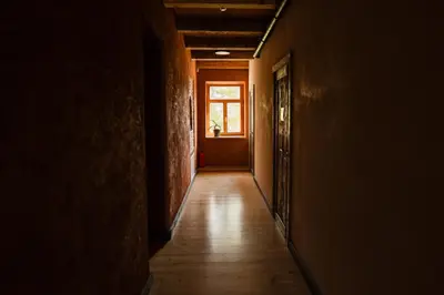 an empty hallway with a door and a window at Inovatorių slėnis/ Innovators' valley in Antalieptė