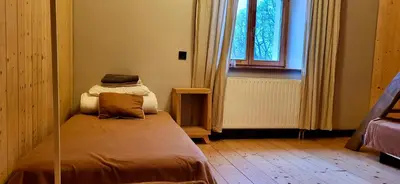 a small room with a bed with a window at Inovatorių slėnis/ Innovators' valley in Antalieptė