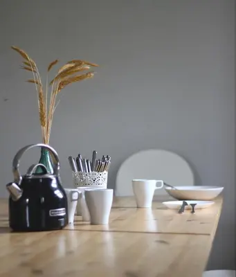 a table with a tea pot and cups on it at Inovatorių slėnis/ Innovators' valley in Antalieptė