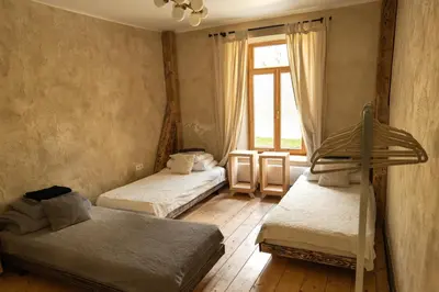 a bedroom with two bunk beds and a window at Inovatorių slėnis/ Innovators' valley in Antalieptė