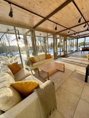 a living room with two couches and a table at Inovatorių slėnis/ Innovators' valley in Antalieptė