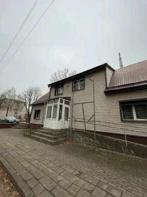 a house with white doors and a brick driveway at Vaižganto Namas House for rent in Raseiniai