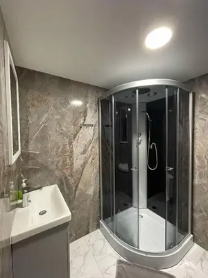 a bathroom with a shower and a sink at Vaižganto Namas House for rent in Raseiniai
