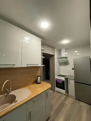 a kitchen with a sink and a refrigerator at Vaižganto Namas House for rent in Raseiniai
