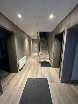 a hallway with a staircase in a house at Vaižganto Namas House for rent in Raseiniai