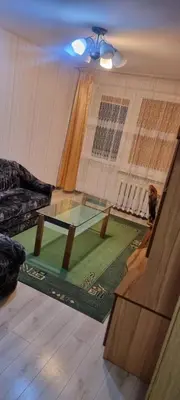 a living room with a table and a couch at Cute Flat in Kėdainiai
