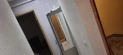a bathroom with a mirror and a door with a shower at Cute Flat in Kėdainiai