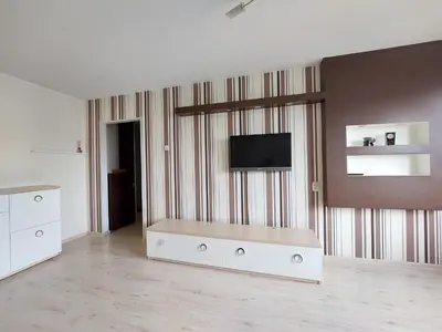 a living room with a flat screen tv on a wall at R&M apartments in Kaunas