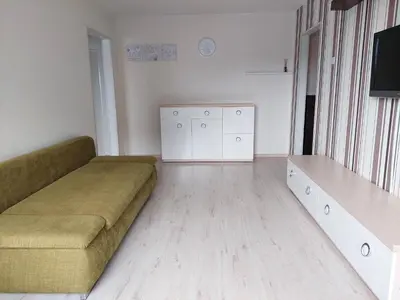 a living room with a couch and a tv at R&M apartments in Kaunas