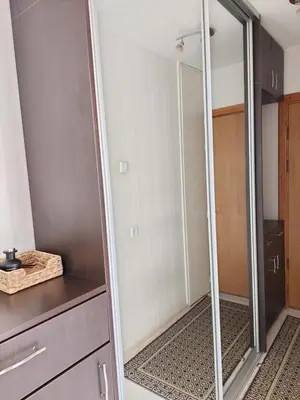 a walk in shower with a mirror in a bathroom at R&M apartments in Kaunas
