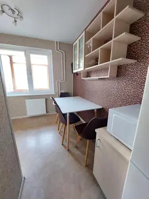 a kitchen with a table and chairs in a room at R&M apartments in Kaunas