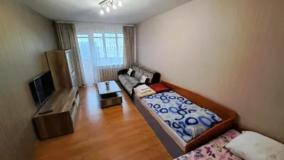 a small living room with a couch and a tv at Apartment Ramune in Šiauliai