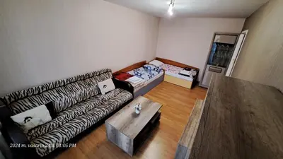 a living room with a couch and a table at Apartment Ramune in Šiauliai