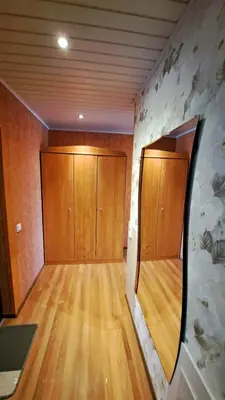 an empty room with wooden doors and wooden floors at Apartment Ramune in Šiauliai