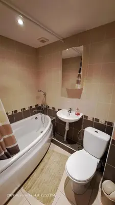 a bathroom with a tub and a toilet and a sink at Apartment Ramune in Šiauliai