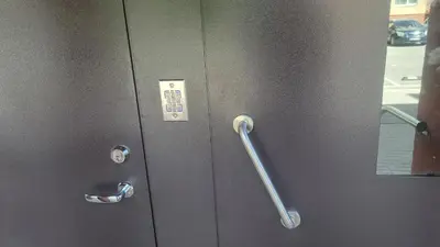 a metal door with a metal handle on a elevator at Apartment Ramune in Šiauliai