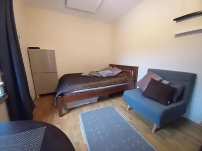 a small room with a bed and a chair at MAIRONIO gt 19-7 in Vilnius