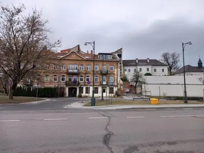 an empty street in front of a large brick building at MAIRONIO gt 19-7 in Vilnius