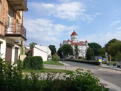 a building with a tower on top of a street at MAIRONIO gt 19-7 in Vilnius