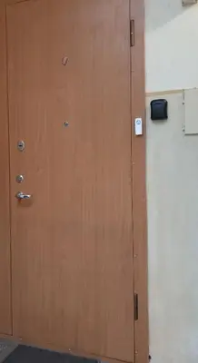 a wooden door in a room with a wall at MAIRONIO gt 19-7 in Vilnius