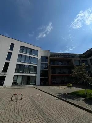 a large building with a bench in front of it at Milastos apartamentai in Birštonas