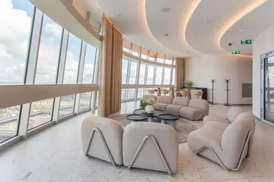 a living room with a lot of windows at Vilnius TV Tower Apartments DEBESYS in Vilnius
