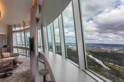 a living room with large windows and a couch at Vilnius TV Tower Apartments DEBESYS in Vilnius