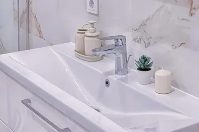 a white bathroom sink with a faucet at Business-class apartments 1 x Free parking x SELF CHECK IN 24x7 in Vilnius