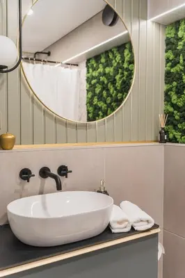 a bathroom with a white sink and a mirror at Old Town view Apartment in city center in Anykščiai