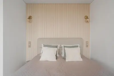 a bedroom with a bed with two pillows at Old Town view Apartment in city center in Anykščiai